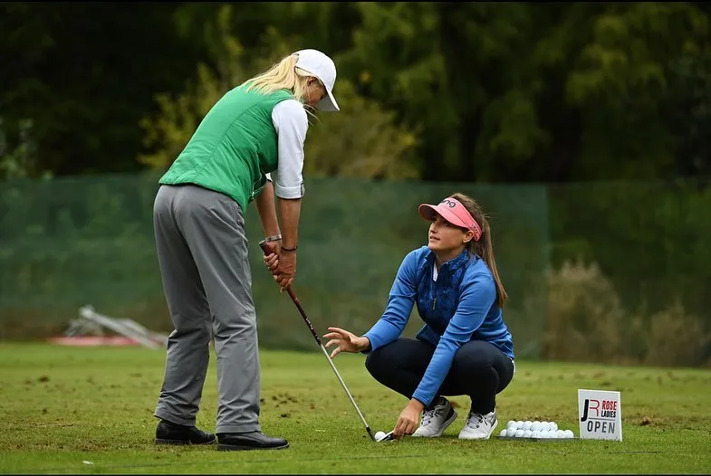 Jae coaching a golfer on the practice ground