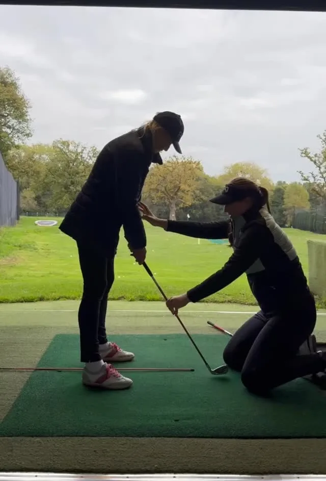 Jae adjusting a student's club position at Marton Meadows